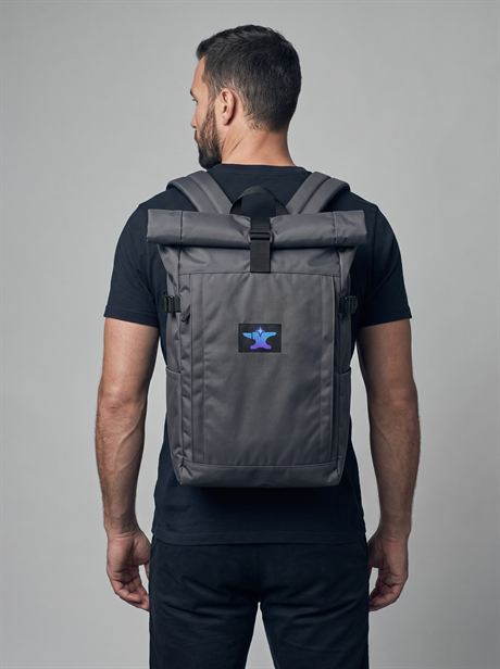 Grey roll-top backpack worn on the back, rear view — AI-generated product photo, same male model, frame 1 of 25