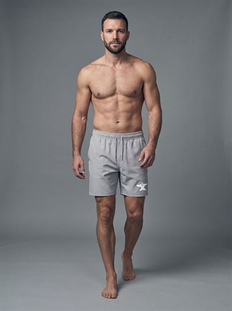 Grey sports shorts, full-length front view — AI-generated product photo, same male model, frame 24 of 25