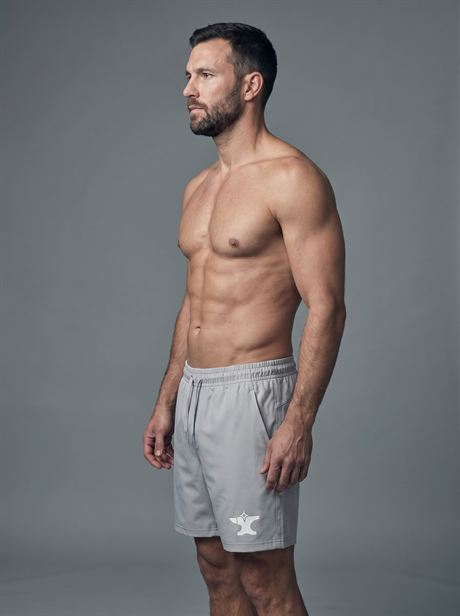 Grey sports shorts, full-length side view — AI-generated product photo, same male model, frame 25 of 25
