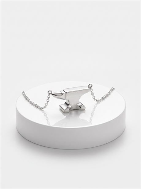 Silver anvil pendant on a round plinth — AI-generated product photo, nobody in the frame, frame 23 of 25