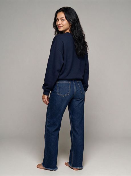 Navy sweatshirt with jeans, rear three-quarter view — AI-generated product photo, same female model, frame 12 of 25